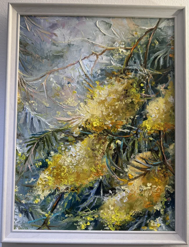 Clusters of yellow blossom and slender dark branches cross a cool grey-blue ground, with thick pale strokes and deep green leaves adding contrast.