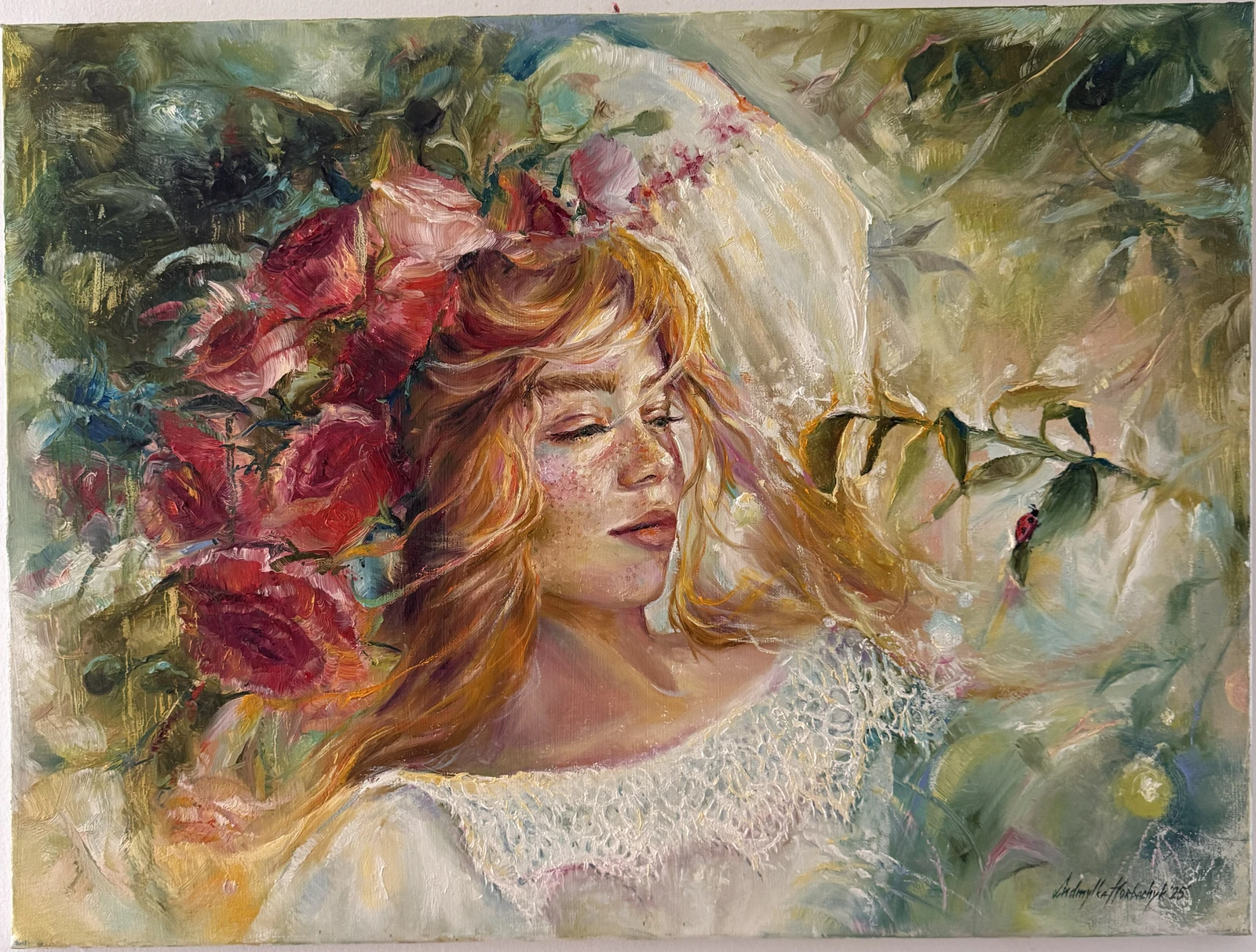 A red-haired woman appears among warm red blossoms and translucent green foliage, with lace-like white textures and small accents of bright colour.